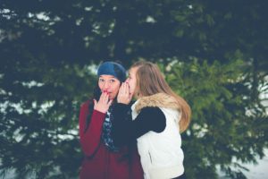 Unsplash, Photo by Ben White, woman whispering on woman's ear while hands on lips, gossip, kepo