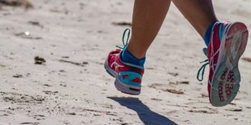 person wearing blue and white sneakers