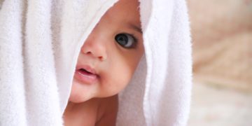baby doll covered with white towel
