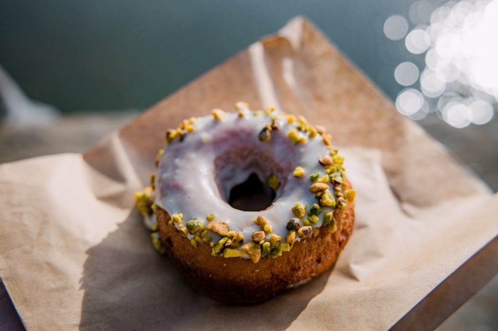 brown doughnut on brown paper bag