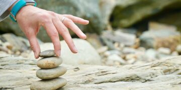 person piling brown stones