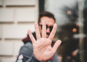 man raising right hand