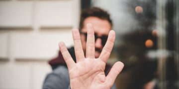 man raising right hand