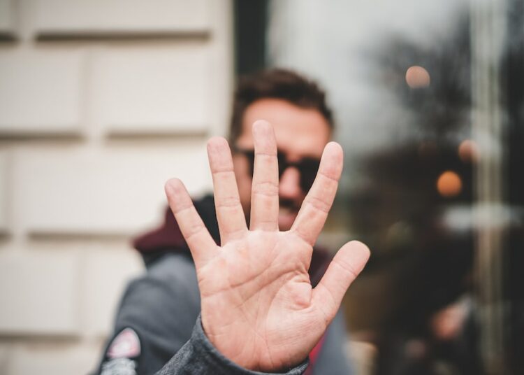 man raising right hand