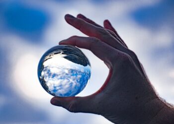 a hand holding a globe