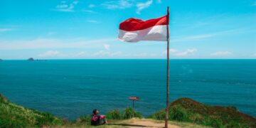 red and white flag beside beach