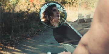 woman riding motorcycle on road