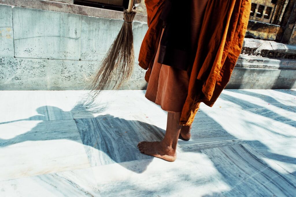 Photograph of Person Sweeping the Floor