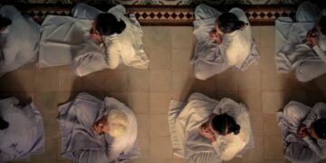 men sitting on white square tile floor