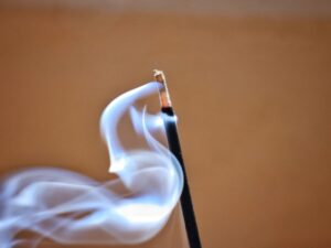 A close up of a matchstick with smoke coming out of it