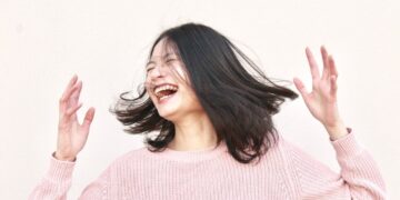 smiling woman wearing pink sweater